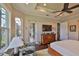 Comfortable main bedroom features tray ceiling, large windows, and access to a screened lanai at 4830 Grand Banks Dr, Wimauma, FL 33598
