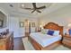 Large main bedroom offering tray ceiling, ample closet space and hardwood flooring at 4830 Grand Banks Dr, Wimauma, FL 33598