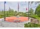 A memorial park adorned with flags and benches offers a tranquil space for reflection and remembrance within the community at 4830 Grand Banks Dr, Wimauma, FL 33598