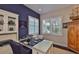 Home office with built-in shelving, natural light, and a functional workspace with views of the front yard at 4830 Grand Banks Dr, Wimauma, FL 33598