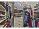 Organized walk-in closet featuring shelving, drawers, and ample storage for clothing and accessories at 4830 Grand Banks Dr, Wimauma, FL 33598