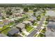 An aerial view showcases a neatly planned neighborhood with lush landscaping and a serene lake at 4852 Trinidad Dr, Land O Lakes, FL 34639