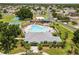 Aerial view of a community pool and clubhouse surrounded by lush landscaping and Gathering friendly recreation at 4852 Trinidad Dr, Land O Lakes, FL 34639
