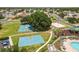 Aerial view features a park with basketball courts, beach volleyball court, playground, pool and lounge area at 4852 Trinidad Dr, Land O Lakes, FL 34639