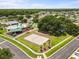 Aerial view of a community park featuring a pool, playground, beach volleyball court and basketball court at 4852 Trinidad Dr, Land O Lakes, FL 34639