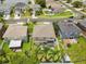 An aerial view of property with a lawn, patio, and fence in a neighborhood setting by the lake at 4852 Trinidad Dr, Land O Lakes, FL 34639