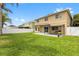 Extensive backyard with a patio, privacy fence, lush green grass, and attractive lawn at 4852 Trinidad Dr, Land O Lakes, FL 34639