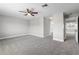 Expansive carpeted bedroom with a ceiling fan and an ensuite bathroom with open doorway at 4852 Trinidad Dr, Land O Lakes, FL 34639
