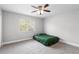 A bedroom that features a ceiling fan, neutral walls, carpet, and a large window at 4852 Trinidad Dr, Land O Lakes, FL 34639