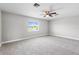 Spacious carpeted bedroom with ceiling fan and natural light from the exterior window at 4852 Trinidad Dr, Land O Lakes, FL 34639