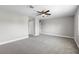 Large bedroom featuring neutral carpeting, ceiling fan, and multiple doorways at 4852 Trinidad Dr, Land O Lakes, FL 34639