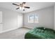 Bedroom with carpet, fan, and a window that offers outdoor views at 4852 Trinidad Dr, Land O Lakes, FL 34639