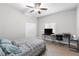 Cozy bedroom with wood-look floors, ceiling fan, closet, and functional desk for work or study at 4852 Trinidad Dr, Land O Lakes, FL 34639