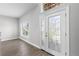 Bright foyer with laminate wood floors, large windows, and a stylish front door with glass panels at 4852 Trinidad Dr, Land O Lakes, FL 34639