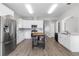 Beautiful kitchen featuring stainless steel appliances, white cabinets, and a stylish center island at 4852 Trinidad Dr, Land O Lakes, FL 34639