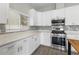 Kitchen showcasing stainless steel appliances, white cabinets, and elegant backsplash at 4852 Trinidad Dr, Land O Lakes, FL 34639