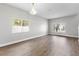 Bright open living area with laminate floors, neutral walls, a chandelier and natural light from windows at 4852 Trinidad Dr, Land O Lakes, FL 34639