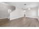Living room with laminate flooring, white walls, chandelier, and stairwell at 4852 Trinidad Dr, Land O Lakes, FL 34639
