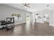 Open-concept living room with view to kitchen perfect for relaxation and gatherings at 4852 Trinidad Dr, Land O Lakes, FL 34639