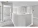 Bright loft area featuring neutral carpet and paint, with open doorway and natural light at 4852 Trinidad Dr, Land O Lakes, FL 34639