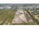 Aerial view showcasing a large, undeveloped land parcel with pond surrounded by lush greenery at 5012 Troydale Rd, Tampa, FL 33615