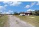 Metal barn with multiple roll-up doors, offering versatile space and functionality on a spacious lot at 5012 Troydale Rd, Tampa, FL 33615