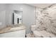 Modern bathroom with granite countertop vanity and tiled walk-in shower at 5012 Troydale Rd, Tampa, FL 33615
