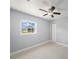 Bright bedroom with tile flooring, closet, ceiling fan, and natural light from the window at 5012 Troydale Rd, Tampa, FL 33615