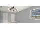 Spacious bedroom with modern ceiling fan and backyard view at 5012 Troydale Rd, Tampa, FL 33615