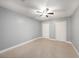 Neutral bedroom with tile floor, ceiling fan and two separate closets at 5012 Troydale Rd, Tampa, FL 33615