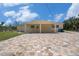 Charming home with a covered entrance, brick paver driveway, and well-maintained lawn at 5012 Troydale Rd, Tampa, FL 33615