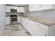Stylish kitchen featuring white cabinets, stainless appliances, and granite countertops at 5012 Troydale Rd, Tampa, FL 33615