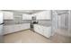 Well-lit kitchen with stainless steel appliances, light countertops, and white cabinets at 5012 Troydale Rd, Tampa, FL 33615