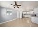 Bright kitchen featuring white cabinets, stainless steel refrigerator, and gray countertops at 5012 Troydale Rd, Tampa, FL 33615