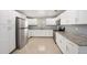 Modern kitchen with sleek stainless steel appliances, granite countertops, and white cabinets at 5012 Troydale Rd, Tampa, FL 33615