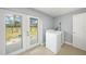 Bright laundry room with new washer and dryer and access to fenced backyard at 5012 Troydale Rd, Tampa, FL 33615