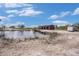 Scenic pond beside a large metal barn, creating a peaceful and functional outdoor space at 5012 Troydale Rd, Tampa, FL 33615