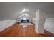 Bright finished attic featuring hardwood floors, a painted brick column, and neutral decor for versatile living at 5301 N Central Ave, Tampa, FL 33603