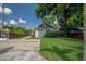 Well-maintained backyard featuring lush green grass, mature trees, and a wooden fence for privacy at 5301 N Central Ave, Tampa, FL 33603