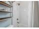 Close up of shower with white subway tiles and storage shelves in remodeled bathroom at 5301 N Central Ave, Tampa, FL 33603