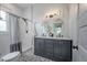 Elegant bathroom featuring a double vanity with oval mirrors, subway tile shower, and patterned tile flooring at 5301 N Central Ave, Tampa, FL 33603
