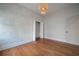 Charming bedroom featuring lovely wallpaper, hardwood floors, and closet at 5301 N Central Ave, Tampa, FL 33603