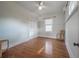 Cozy bedroom with wood floors, natural light, closet, and ceiling fan at 5301 N Central Ave, Tampa, FL 33603