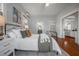 Well-lit bedroom features hardwood floors, a comfortable bed, a nightstand, and stylish décor at 5301 N Central Ave, Tampa, FL 33603