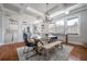 Bright dining room with exposed beams, stylish light fixtures, and a seamless transition to the open-concept kitchen at 5301 N Central Ave, Tampa, FL 33603