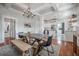 Elegant dining room showcasing hardwood floors, a stylish table setting, and an open view to the modern kitchen at 5301 N Central Ave, Tampa, FL 33603