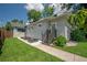 Charming home featuring a side entrance, manicured lawn, and fresh landscaping, enhancing curb appeal at 5301 N Central Ave, Tampa, FL 33603