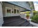 Inviting front porch with stylish lighting, classic columns, and a painted door, creating curb appeal at 5301 N Central Ave, Tampa, FL 33603