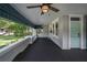 Well-appointed front porch with ceiling fan, decorative railing, and views of the landscaped front yard at 5301 N Central Ave, Tampa, FL 33603