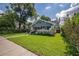 Inviting home featuring lush lawn, mature landscaping, and a welcoming front porch, set in a desirable neighborhood at 5301 N Central Ave, Tampa, FL 33603